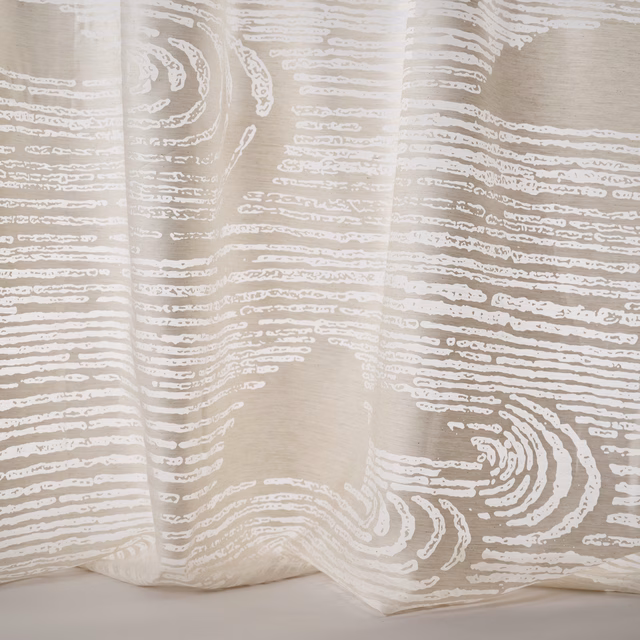 Pale sand abstract patterned fabric with flowing white linear motif and soft drape