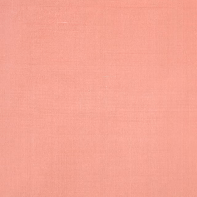 Soft salmon pink silk swatch with a fine plain weave and subtle sheen