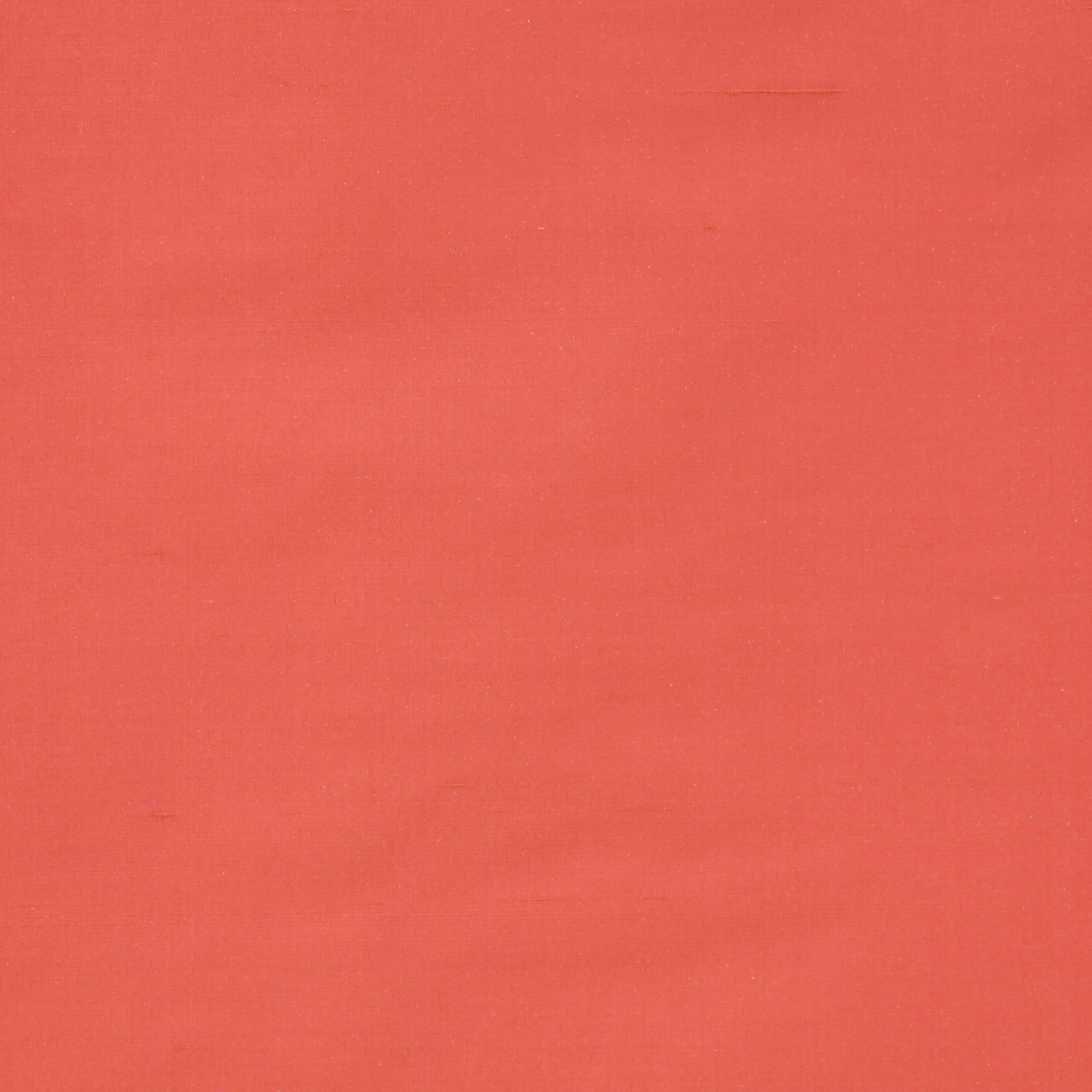 Plain coral-red silk fabric with a smooth, lustrous surface