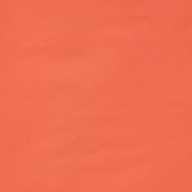 Plain coral-red silk fabric with a smooth, lustrous surface