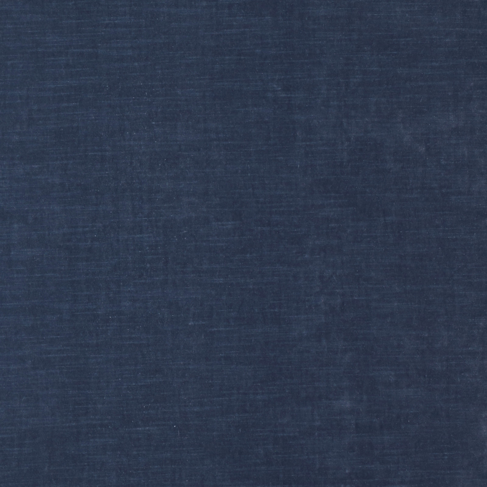 Close-up of a muted denim-blue plain woven fabric with a softly mottled texture