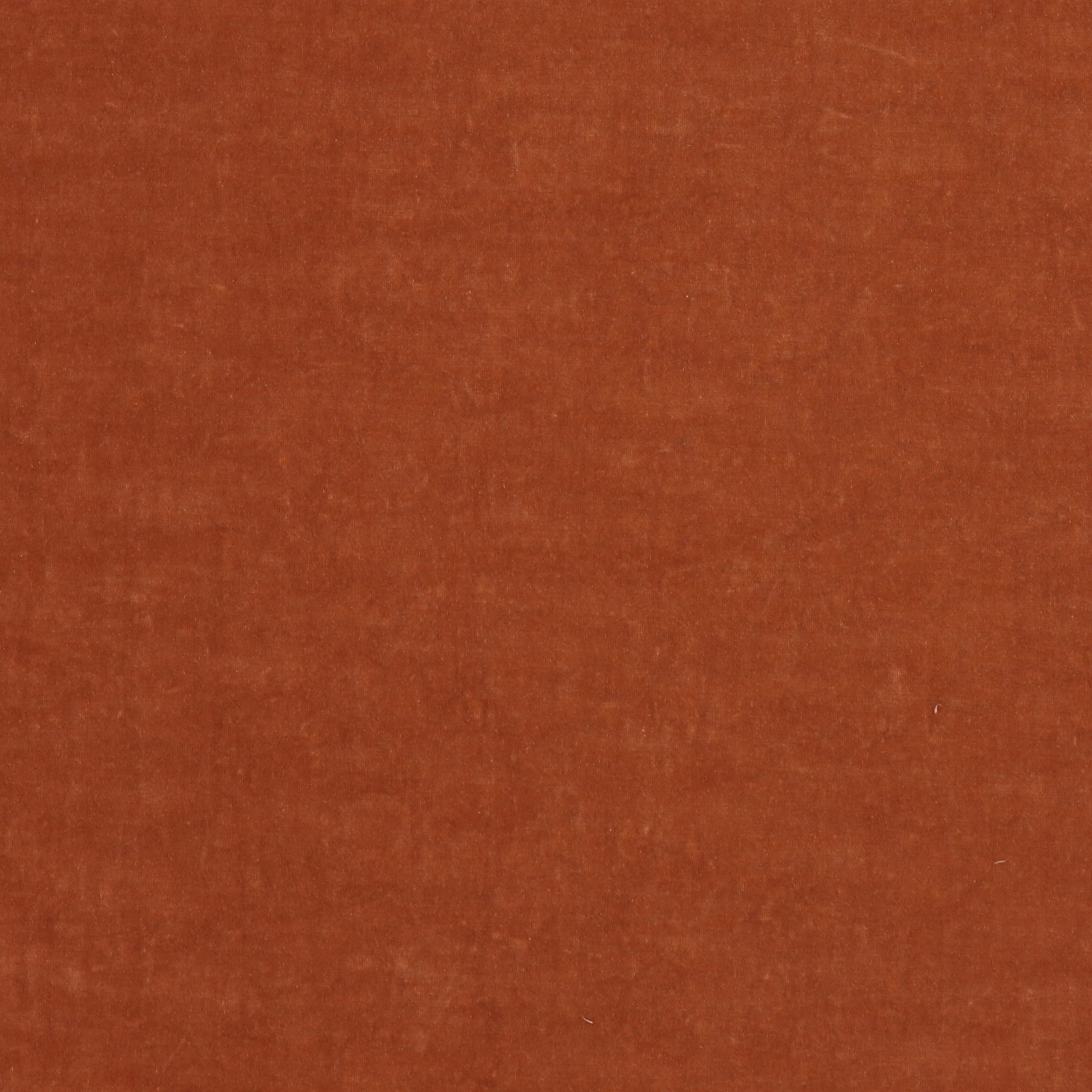 Close-up of plain burnt rust-orange fabric with a soft woven texture