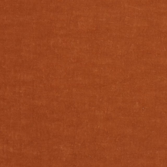 Close-up of plain burnt rust-orange fabric with a soft woven texture