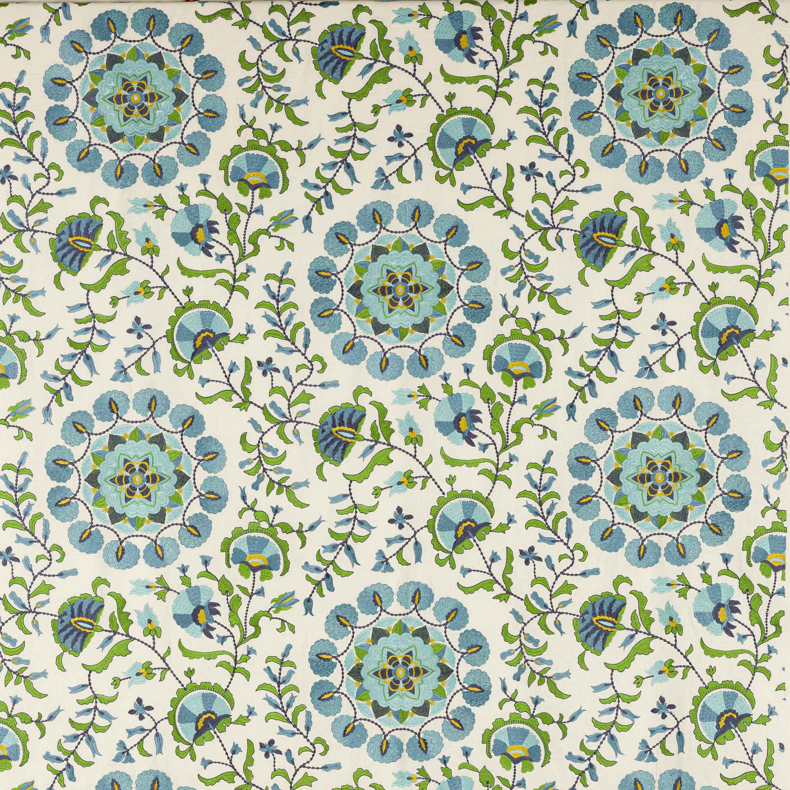 Large celeste blue floral medallions with green vines on a cream fabric ground