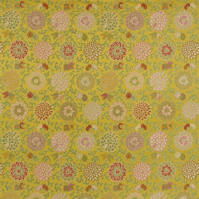 Lively floral fabric swatch on a moss-yellow ground with cream, pink and terracotta motifs