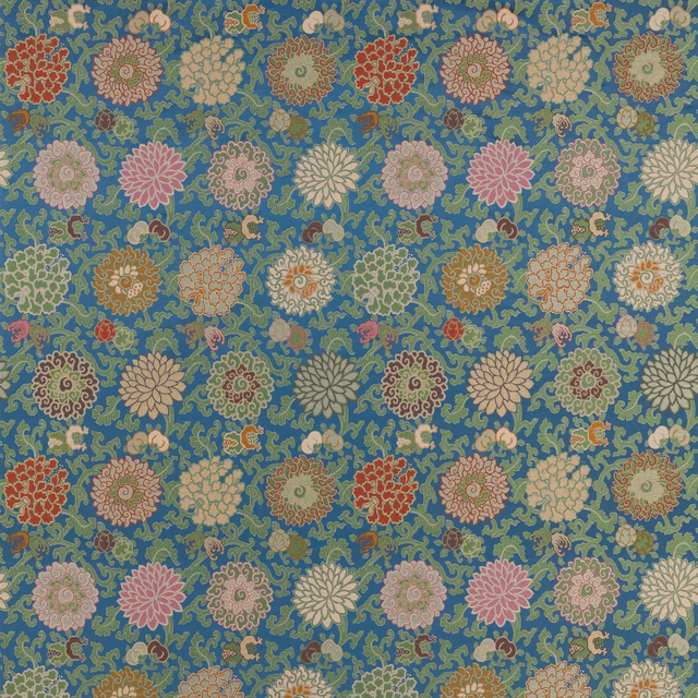 Blue floral fabric swatch with scrolling motifs and multicoloured blossom medallions