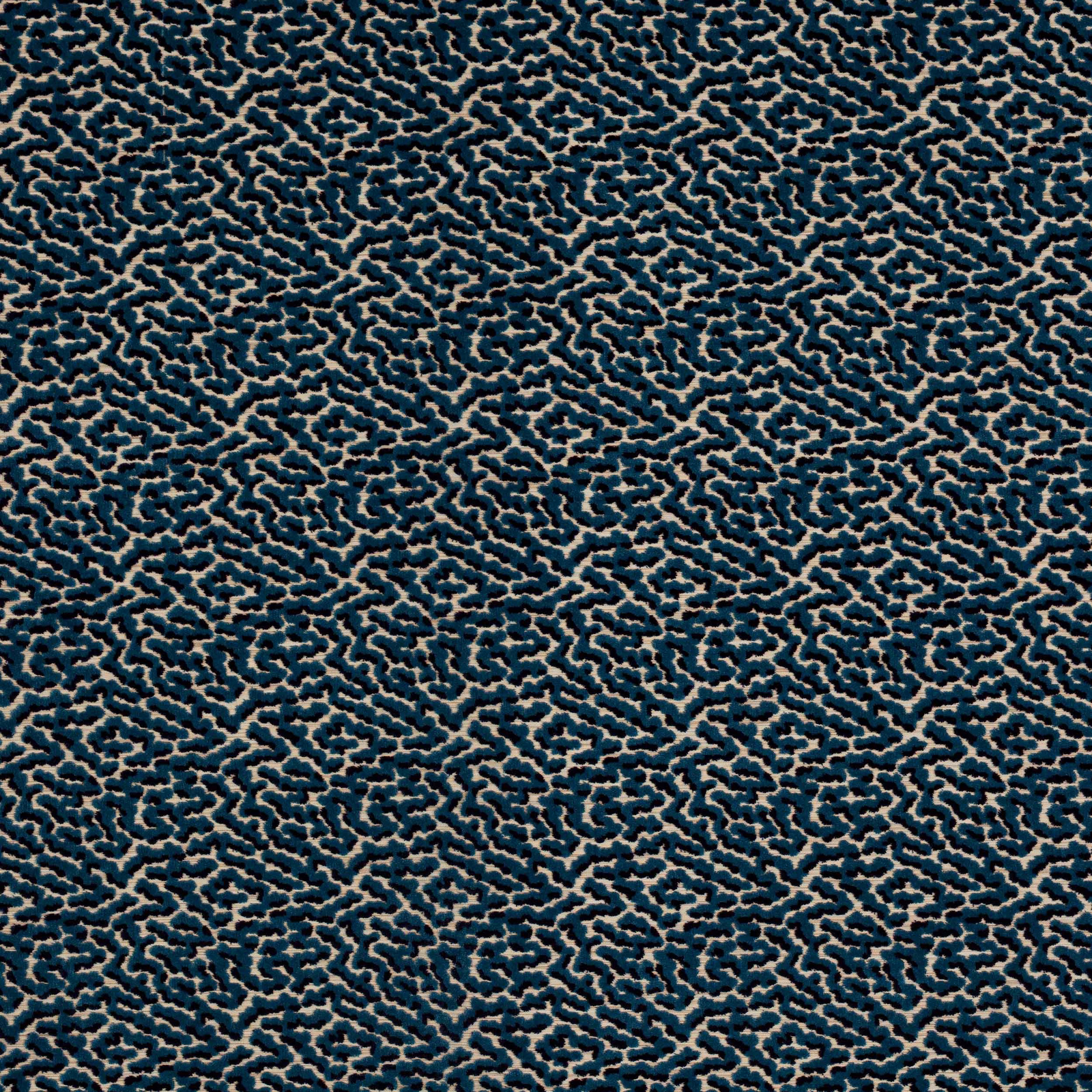 Close-up of small-scale teal-blue patterned fabric with beige outlines