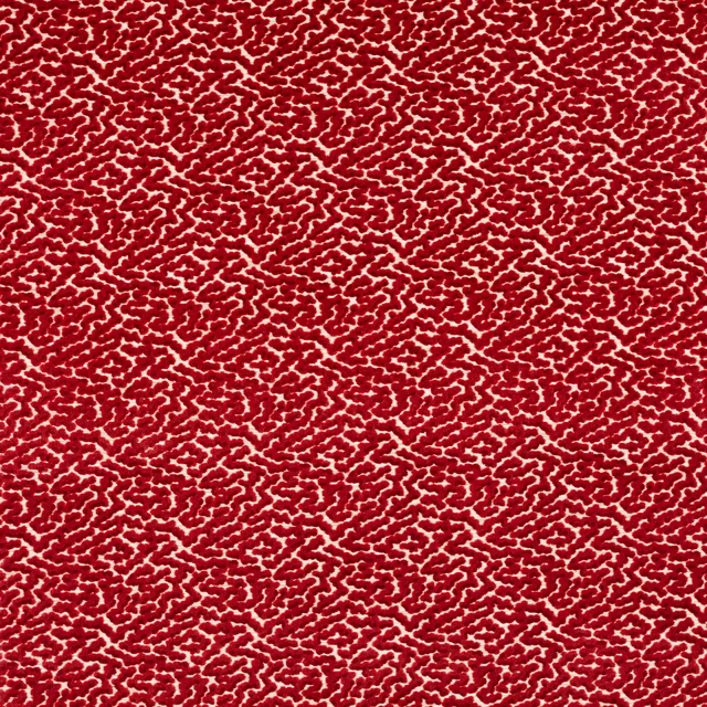 Close-up of a small-scale red patterned fabric with a dense, textured repeat