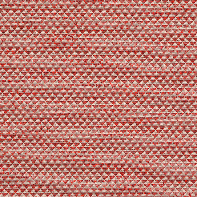 Small-scale red and ivory woven fabric with a tight repeating motif and textured surface