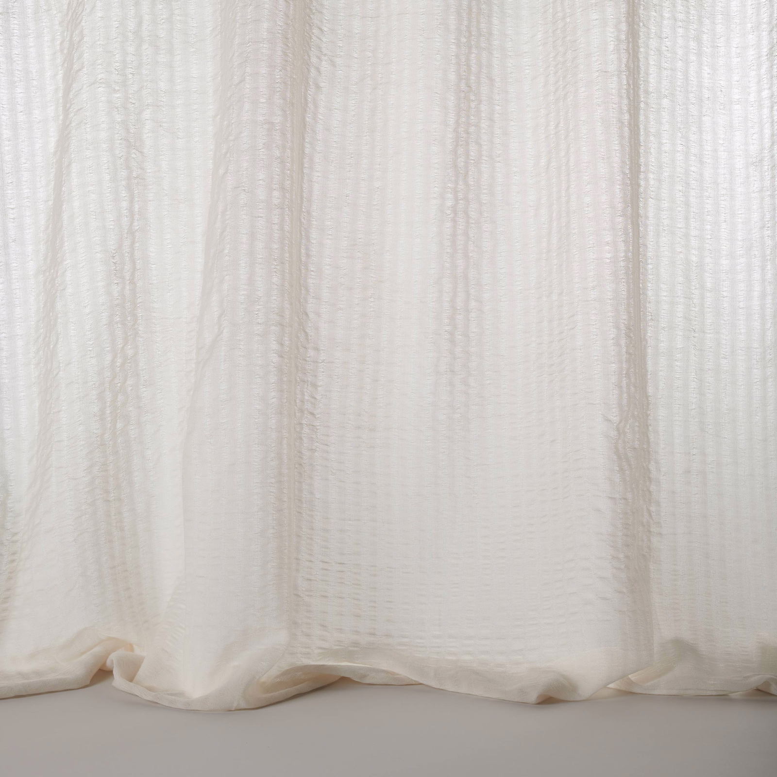 Soft bone cream sheer fabric with fine vertical texture and gentle drape