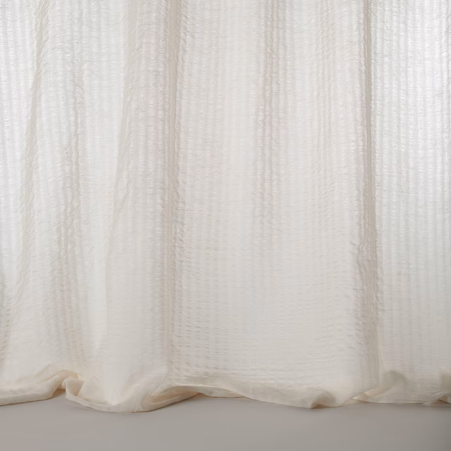 Soft bone cream sheer fabric with fine vertical texture and gentle drape