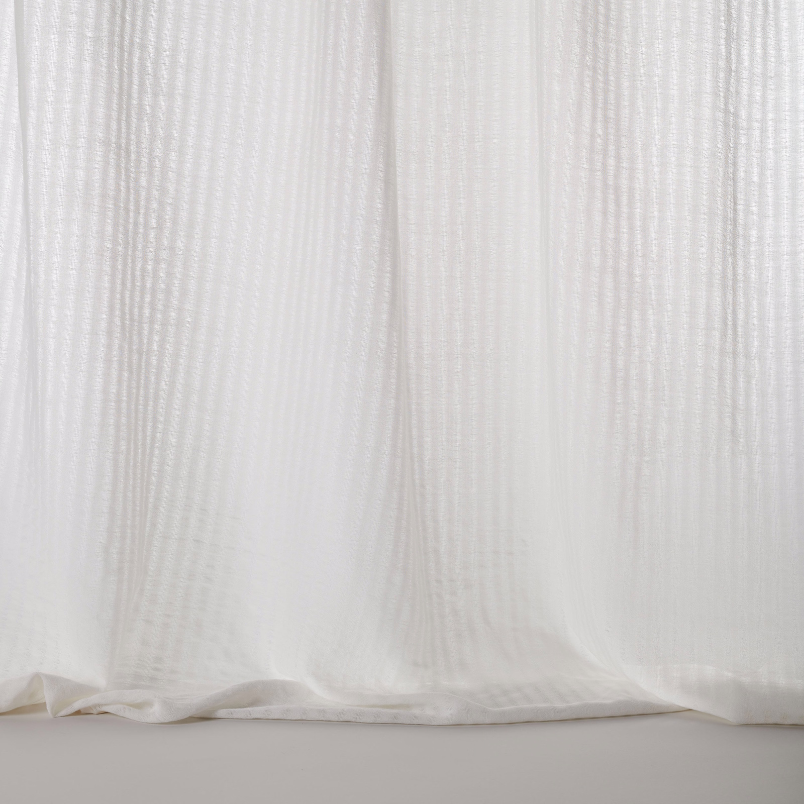 Sheer ivory-white fabric with subtle vertical stripe texture and soft drape
