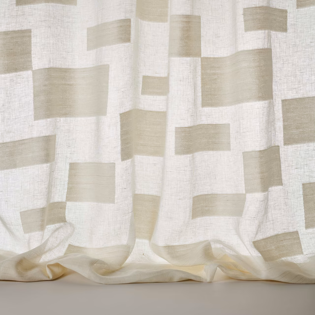 Pale cream geometric block fabric with a soft linen texture and flowing drape
