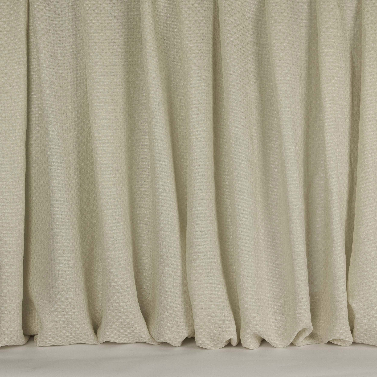 Pale clay-beige linen fabric with subtle small woven texture and soft drape folds