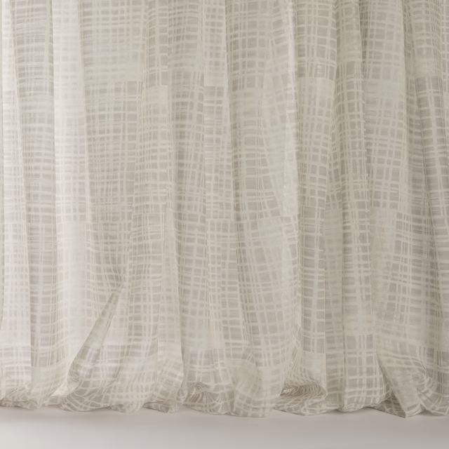Pale ivory-beige sheer fabric with a fine abstract grid pattern and soft drape