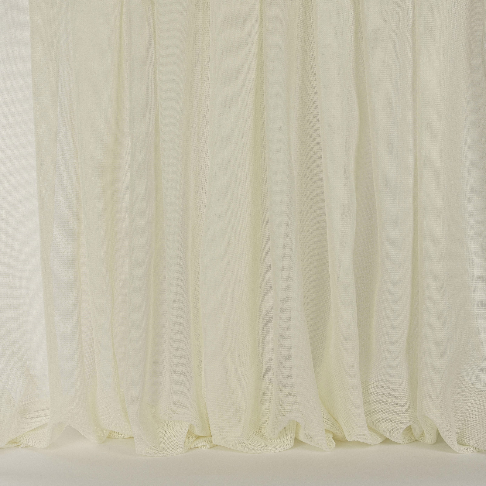 Soft cream sheer curtain fabric with fine vertical texture and gentle folds