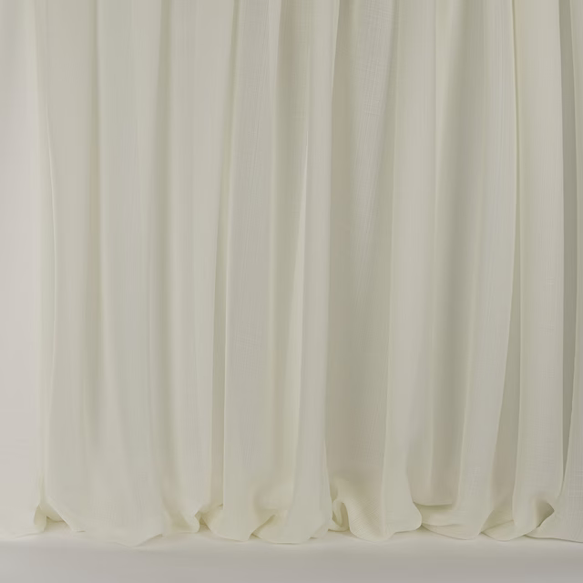 Soft ivory cream drapery with gentle vertical folds and a smooth wool-silk sheen