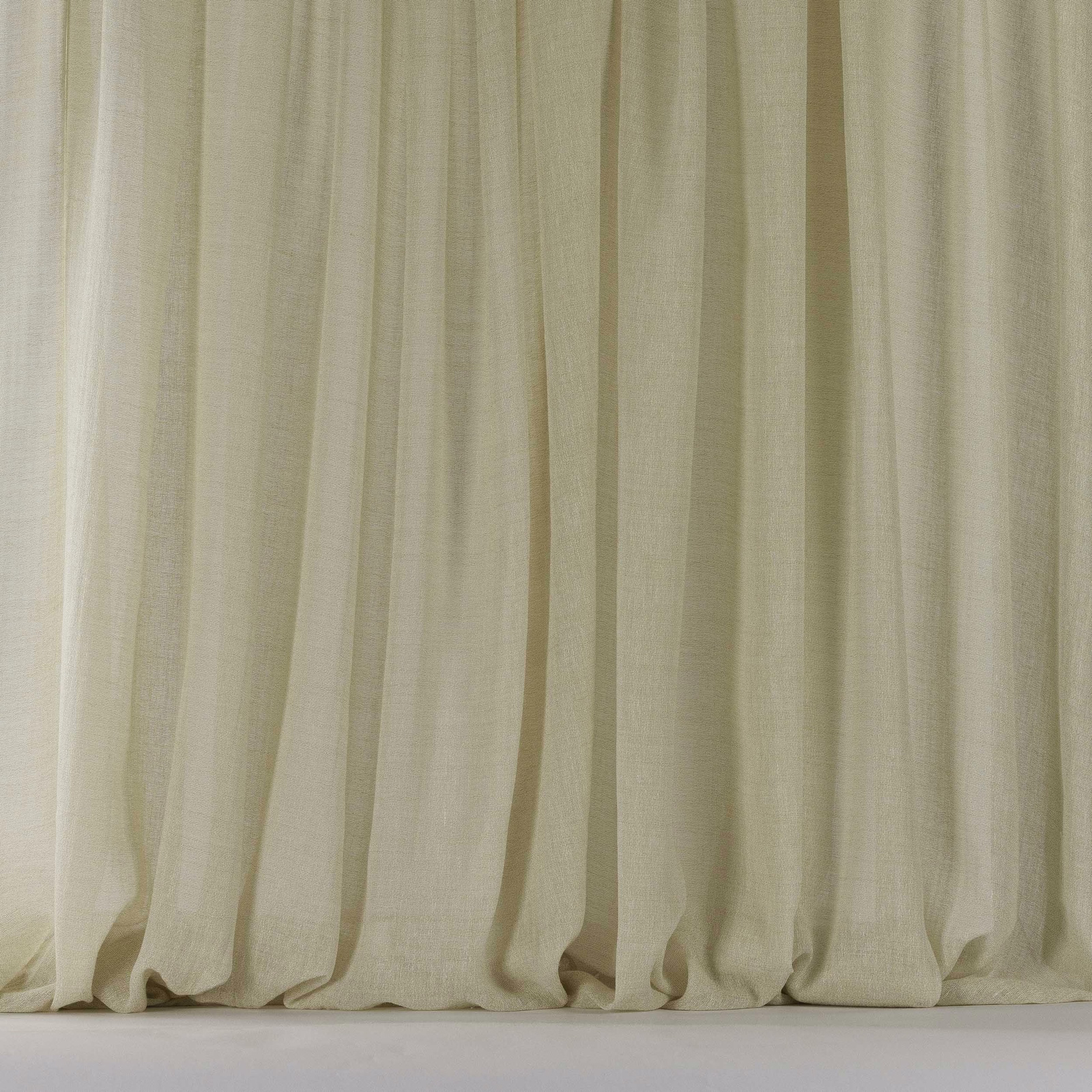Soft warm beige linen-blend fabric hanging in gentle vertical folds