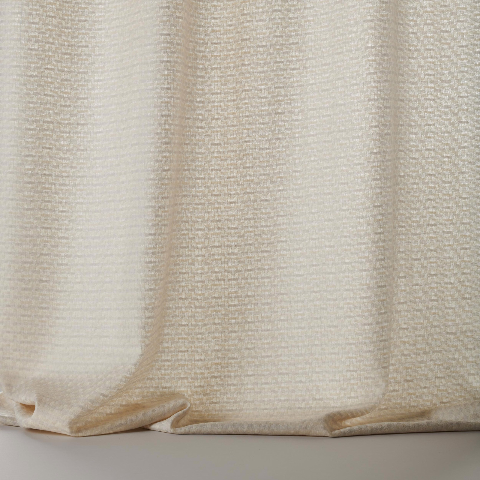 Cream wool fabric swatch with fine woven texture and subtle vertical folds