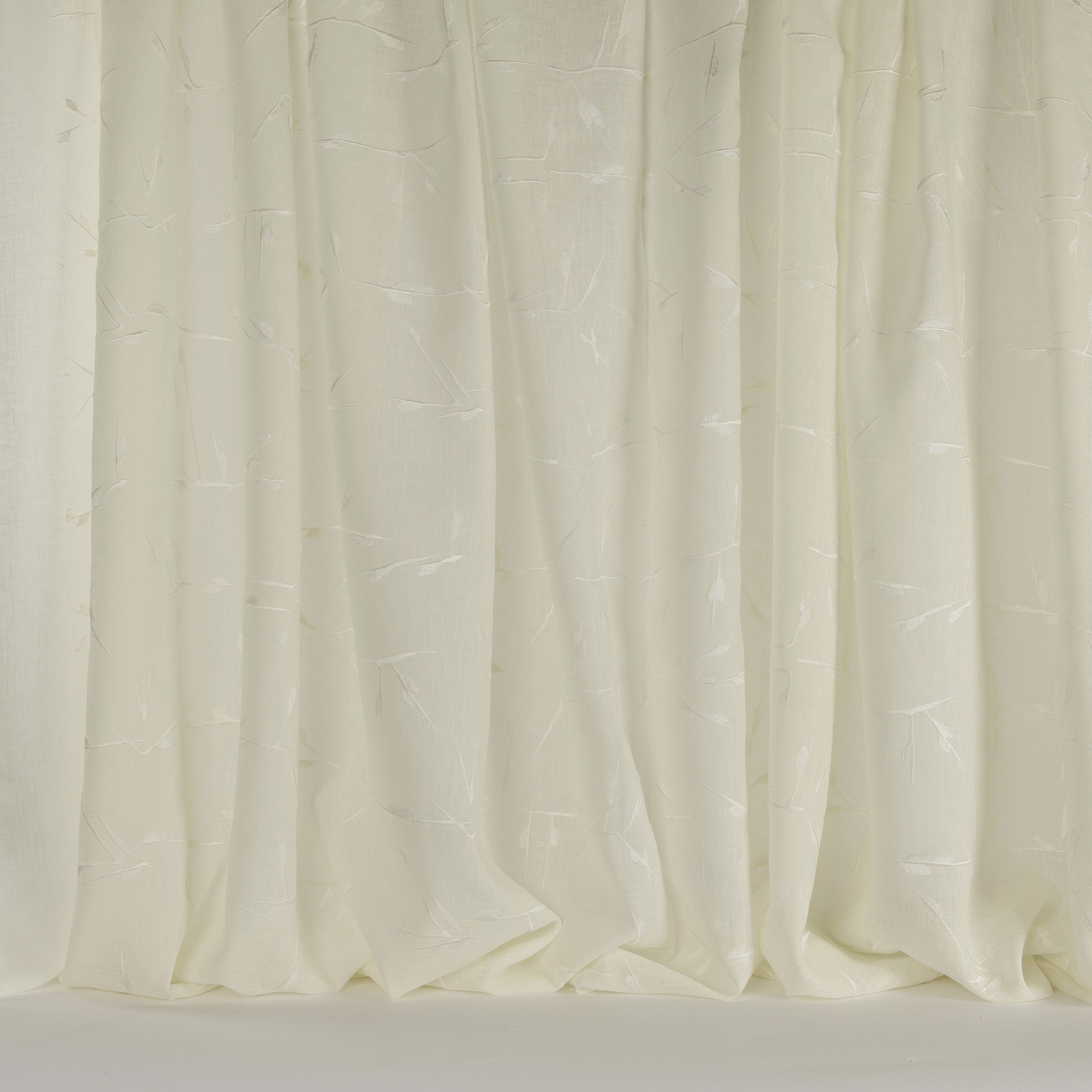 Cream fabric swatch with subtle geometric texture and soft vertical folds