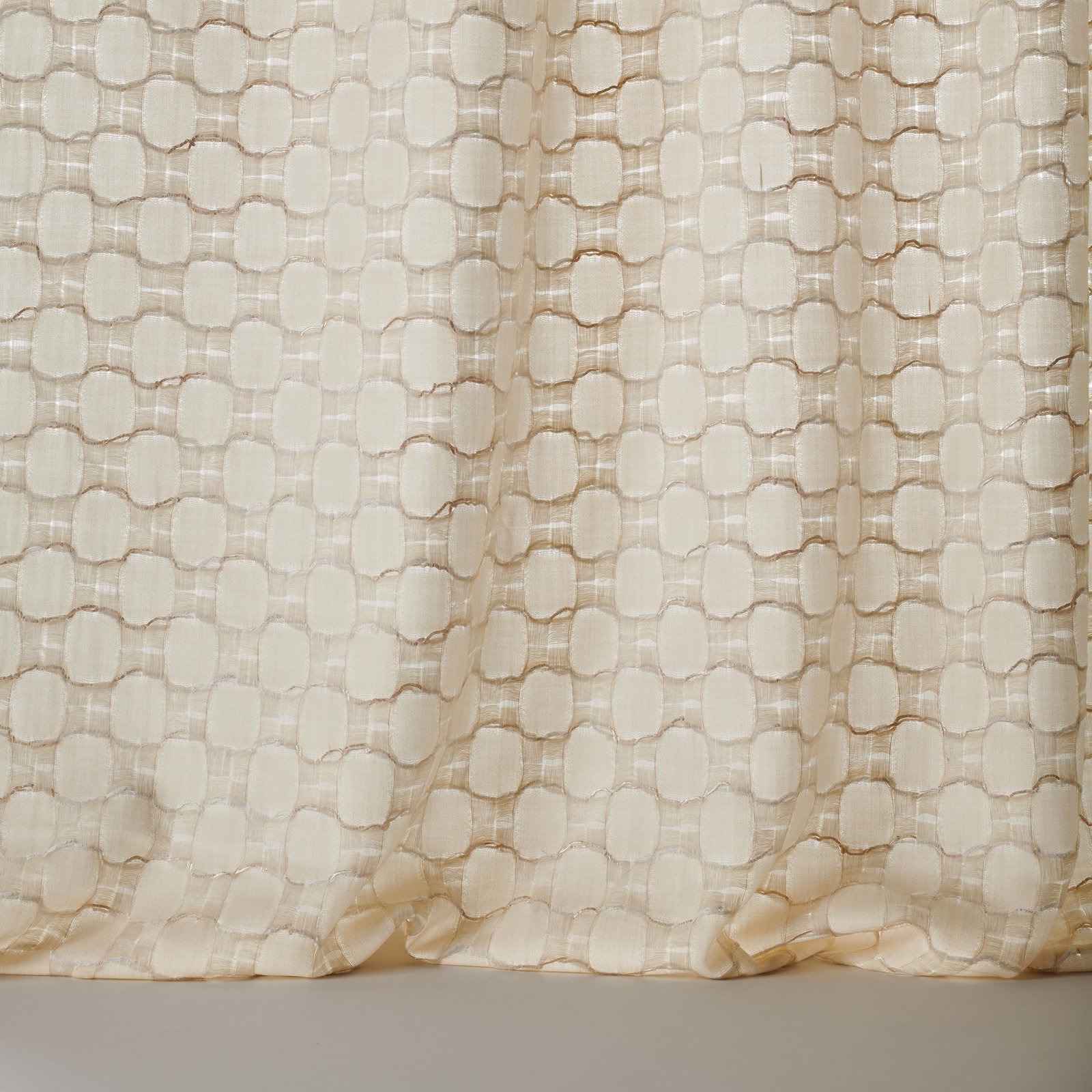 Cream textured fabric with small geometric woven motif and soft drape