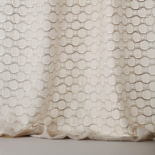 Pale silver-cream woven fabric with raised rounded textured pattern