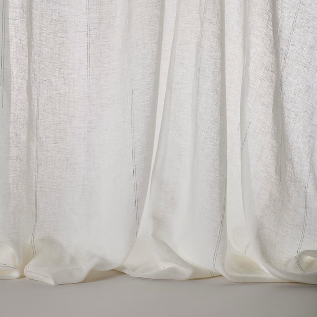 Soft white linen blend curtain fabric with faint vertical stripe texture and relaxed drape