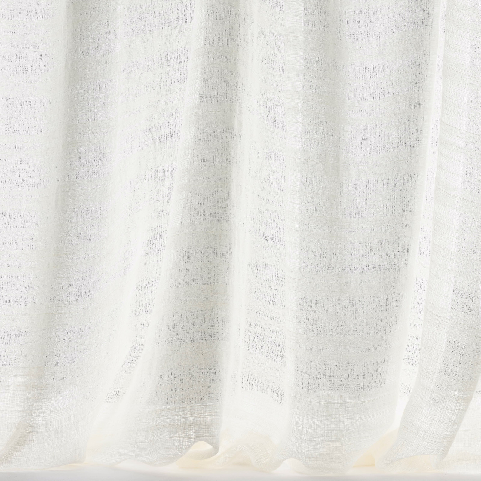 Pale bone ivory curtain fabric with a softly slubbed, semi-sheer weave