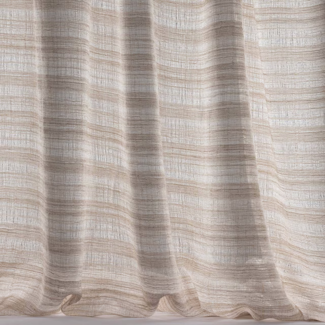 Soft sandy beige woven fabric with fine horizontal striations and fluid drape
