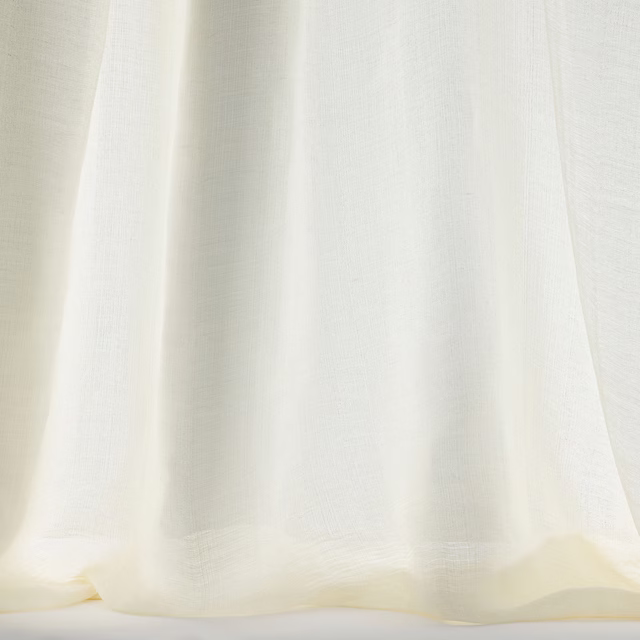 Pale bone cream woven fabric hanging in soft vertical folds