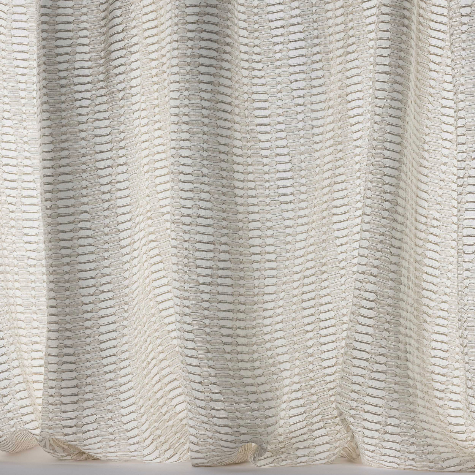 Cream textured woven fabric with subtle linear repeat and soft drape folds