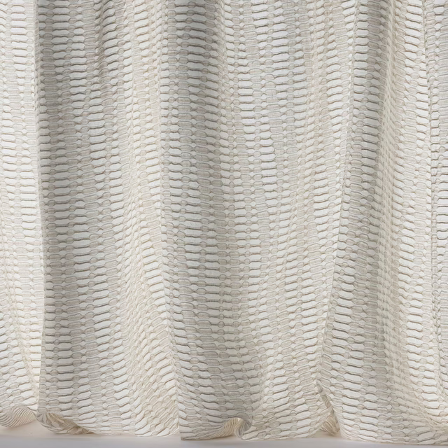 Cream textured woven fabric with subtle linear repeat and soft drape folds