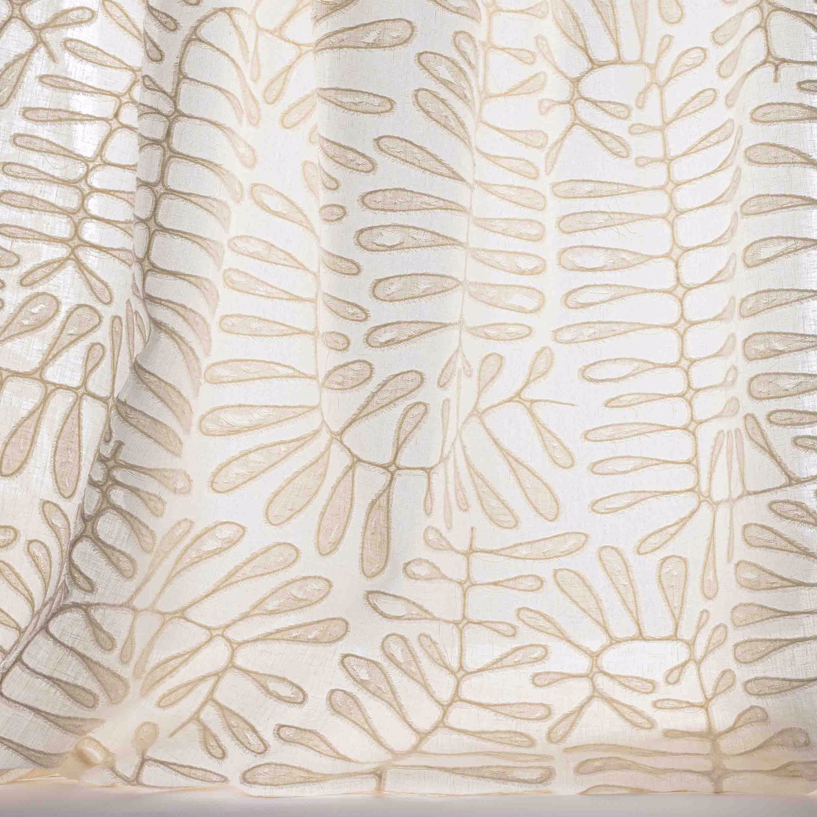Ivory fabric swatch with large pale sand embroidered leaf motif