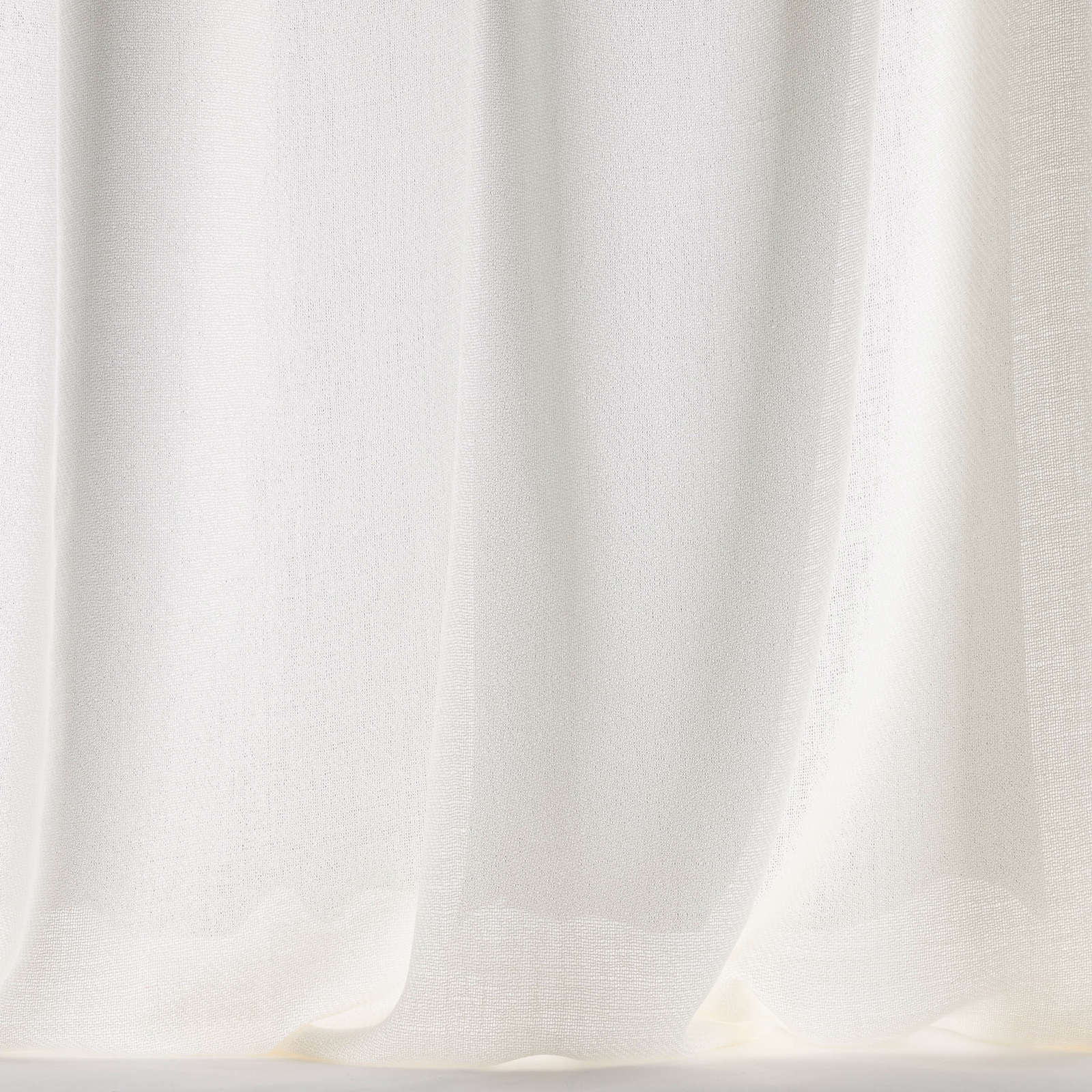 Soft bone-white wool fabric hanging in gentle vertical folds