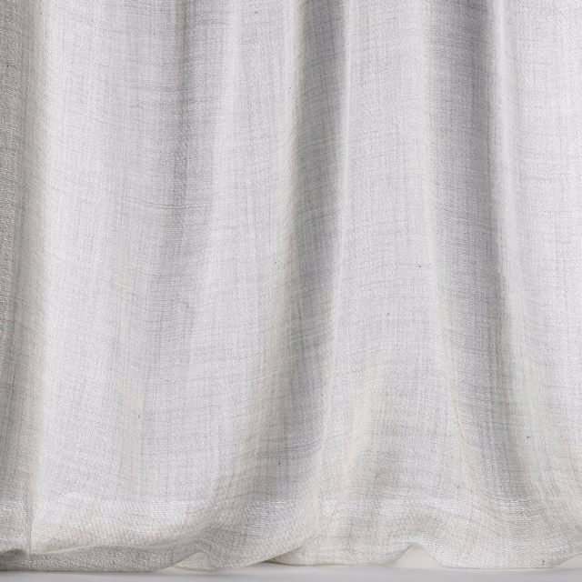 Soft silvery grey wool fabric with a fine woven texture and gentle folds