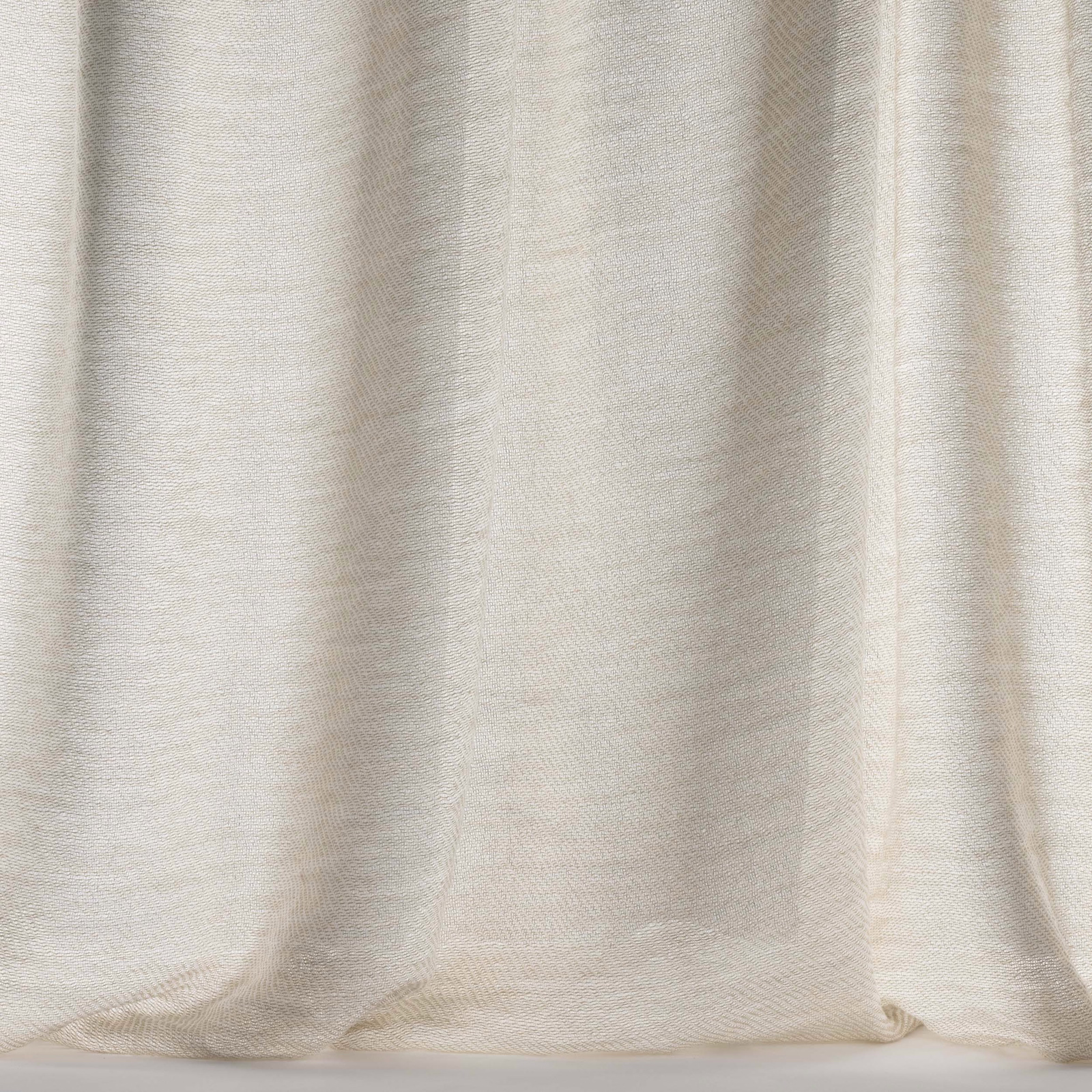 Soft oatmeal cream wool fabric with fine woven texture and relaxed folds