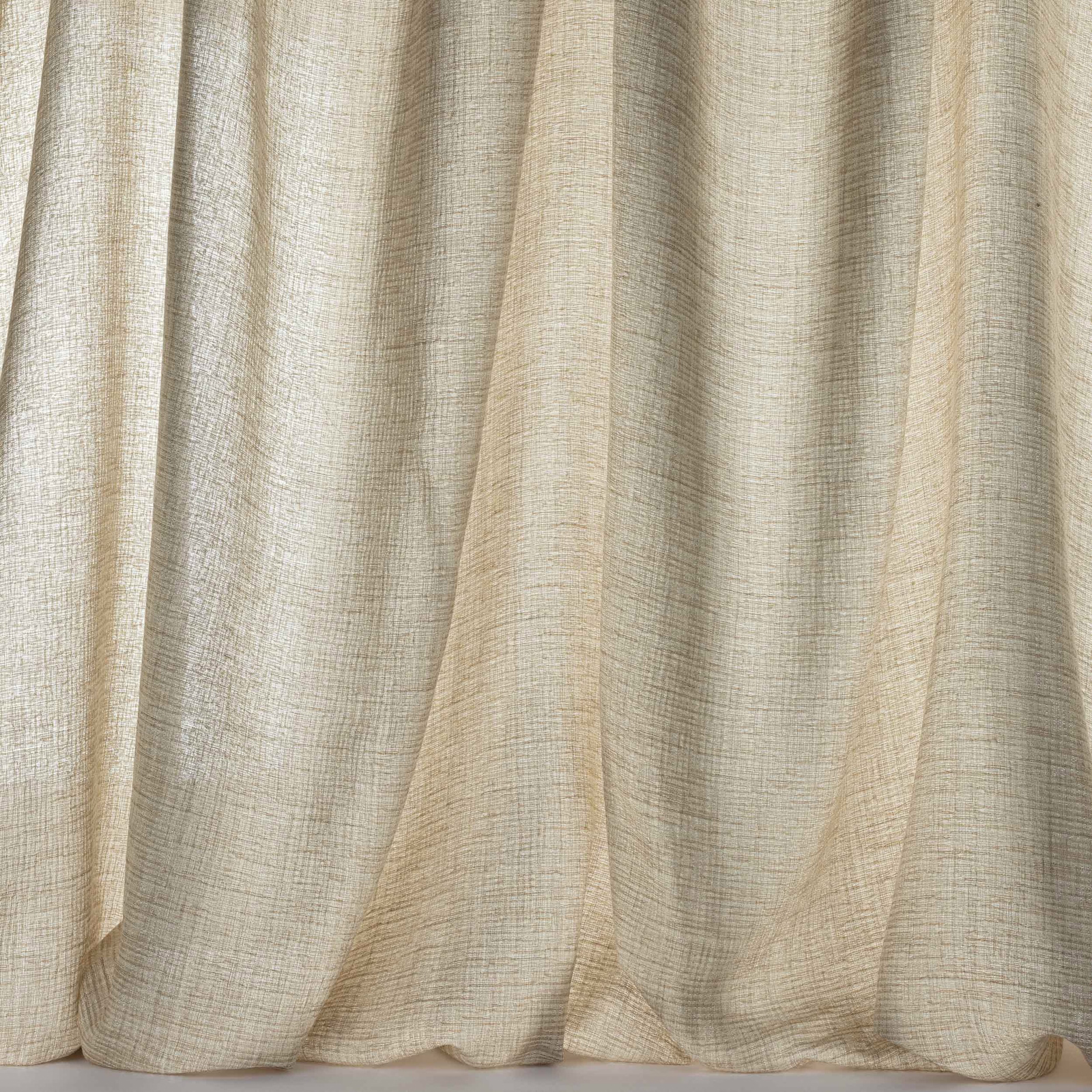 Soft sand beige textured fabric hanging in gentle vertical folds