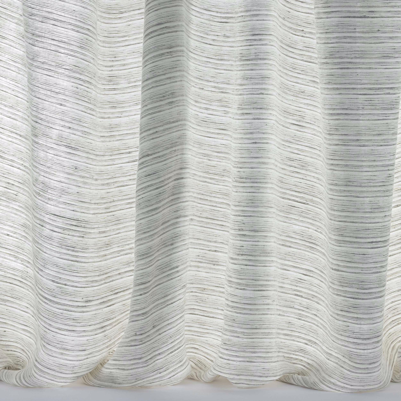 Pale chalky linen fabric with fine horizontal striations and soft drape