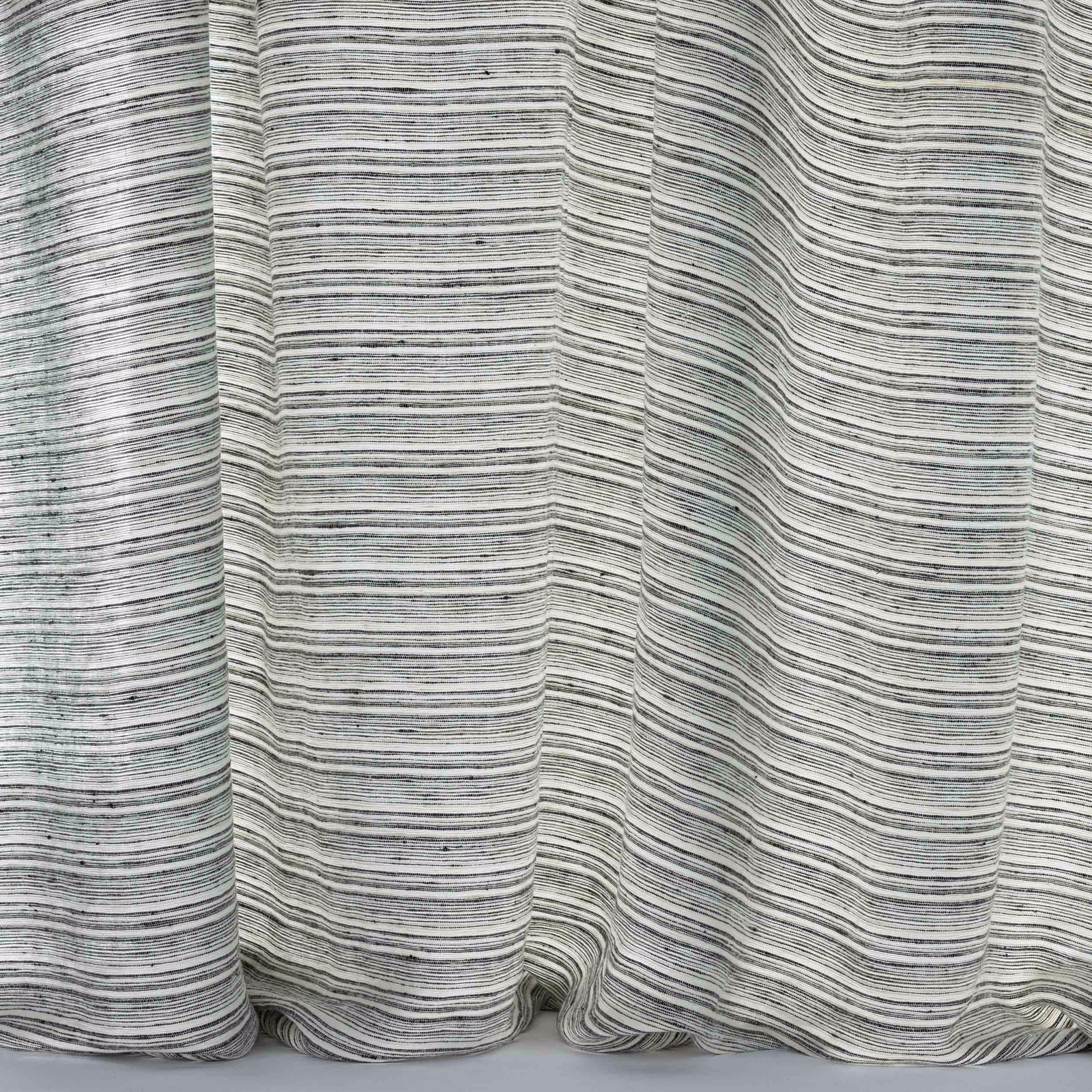 Close-up of softly striped grey linen with fine black flecked threads