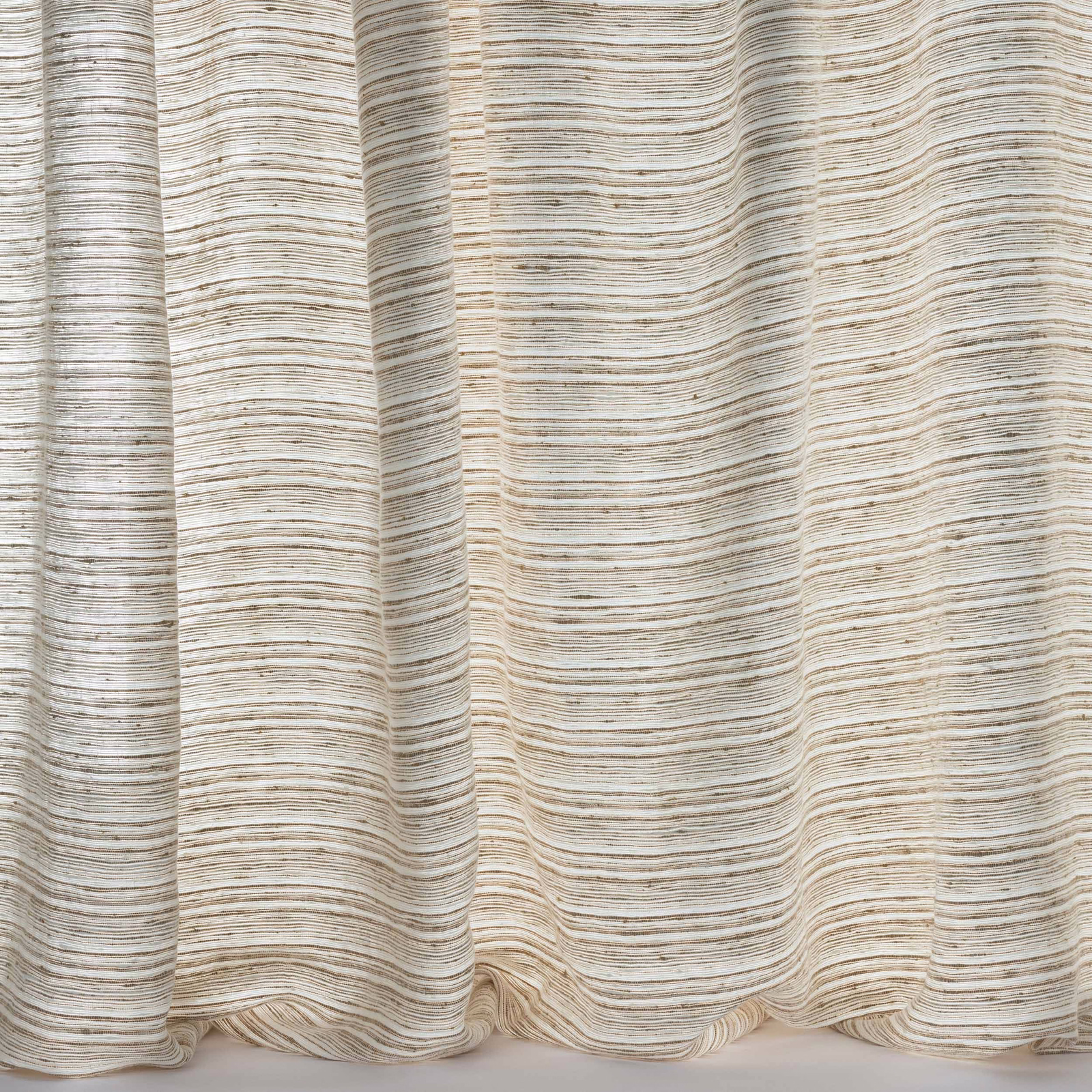 Soft sand-beige linen fabric with fine horizontal striations and draped folds