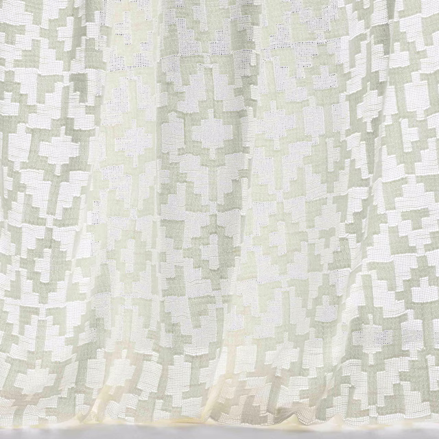 Pale bone cream geometric fabric with soft sage-grey blocks and a subtle woven texture