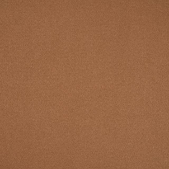 Warm terracotta-canelle plain cotton fabric swatch with fine woven texture