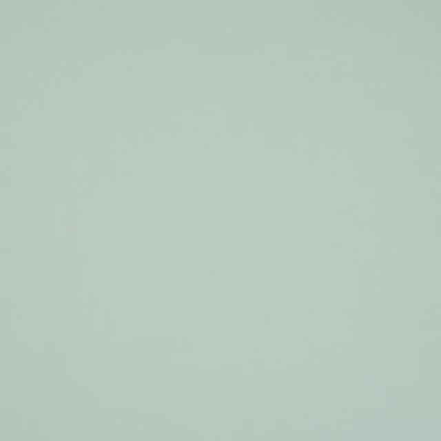 Plain soft celadon green cotton fabric swatch with a matte finish