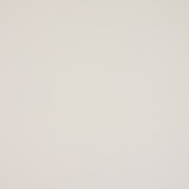 Soft warm ecru plain cotton fabric swatch with a matte finish