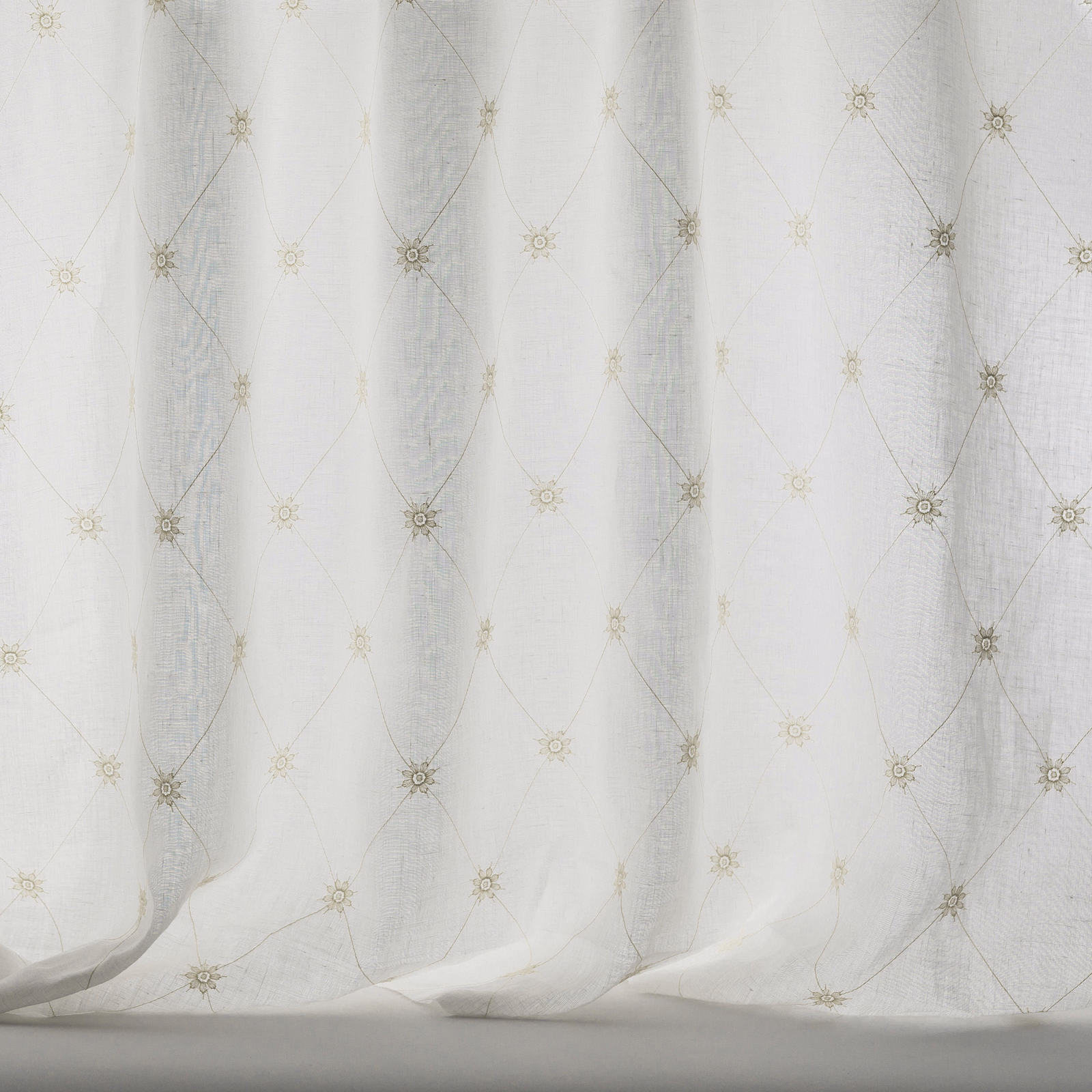 Pale beige sheer fabric with small trellis motifs and soft linen texture