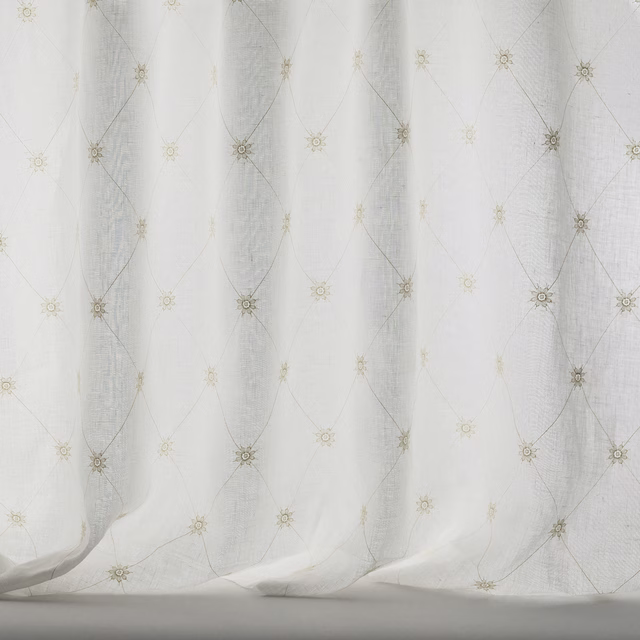 Pale beige sheer fabric with small trellis motifs and soft linen texture