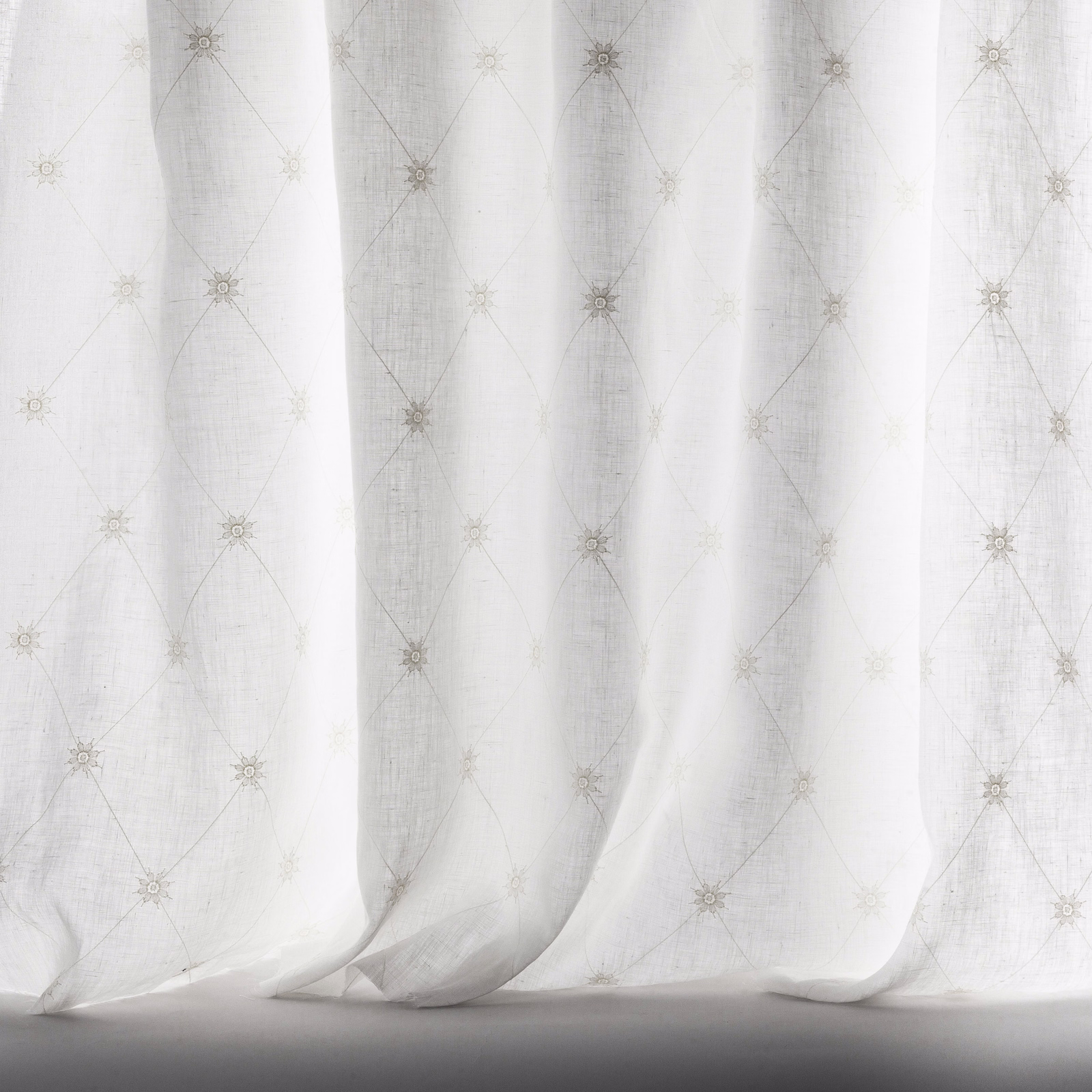 Ivory sheer fabric with fine trellis pattern and tiny rosette motifs
