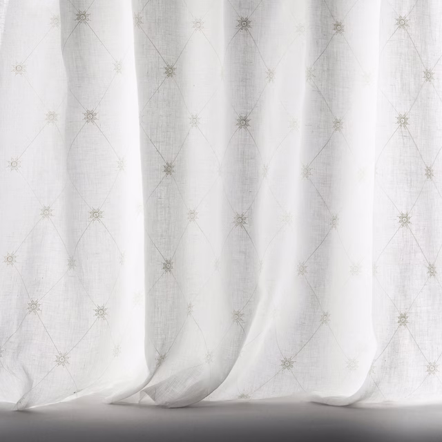Ivory sheer fabric with fine trellis pattern and tiny rosette motifs