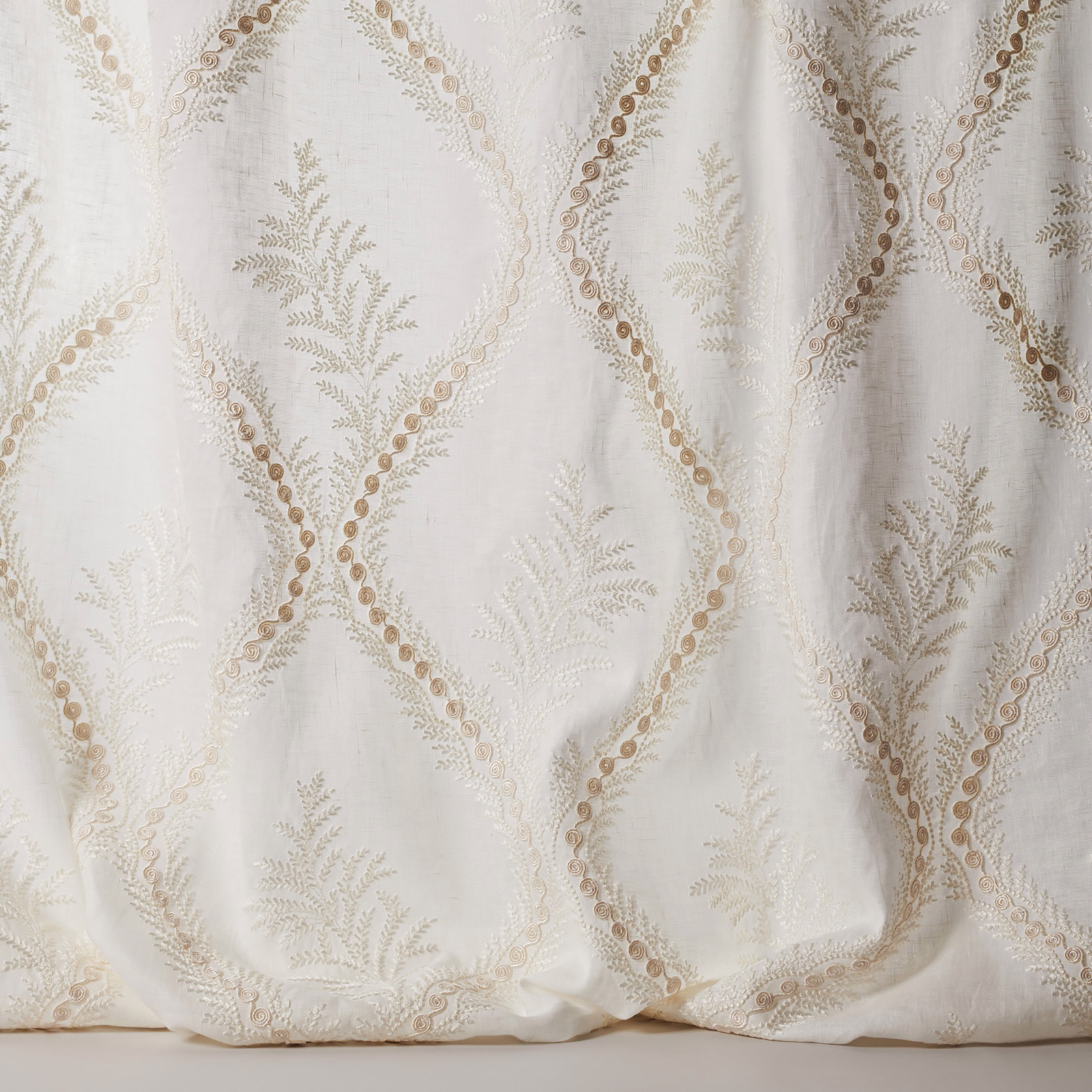 Ivory sheer fabric with embroidered diamond lattice and botanical sprigs
