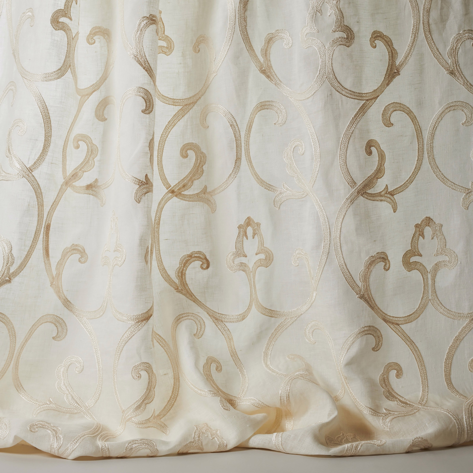 Ivory sheer fabric with large scrolling damask in warm beige tones